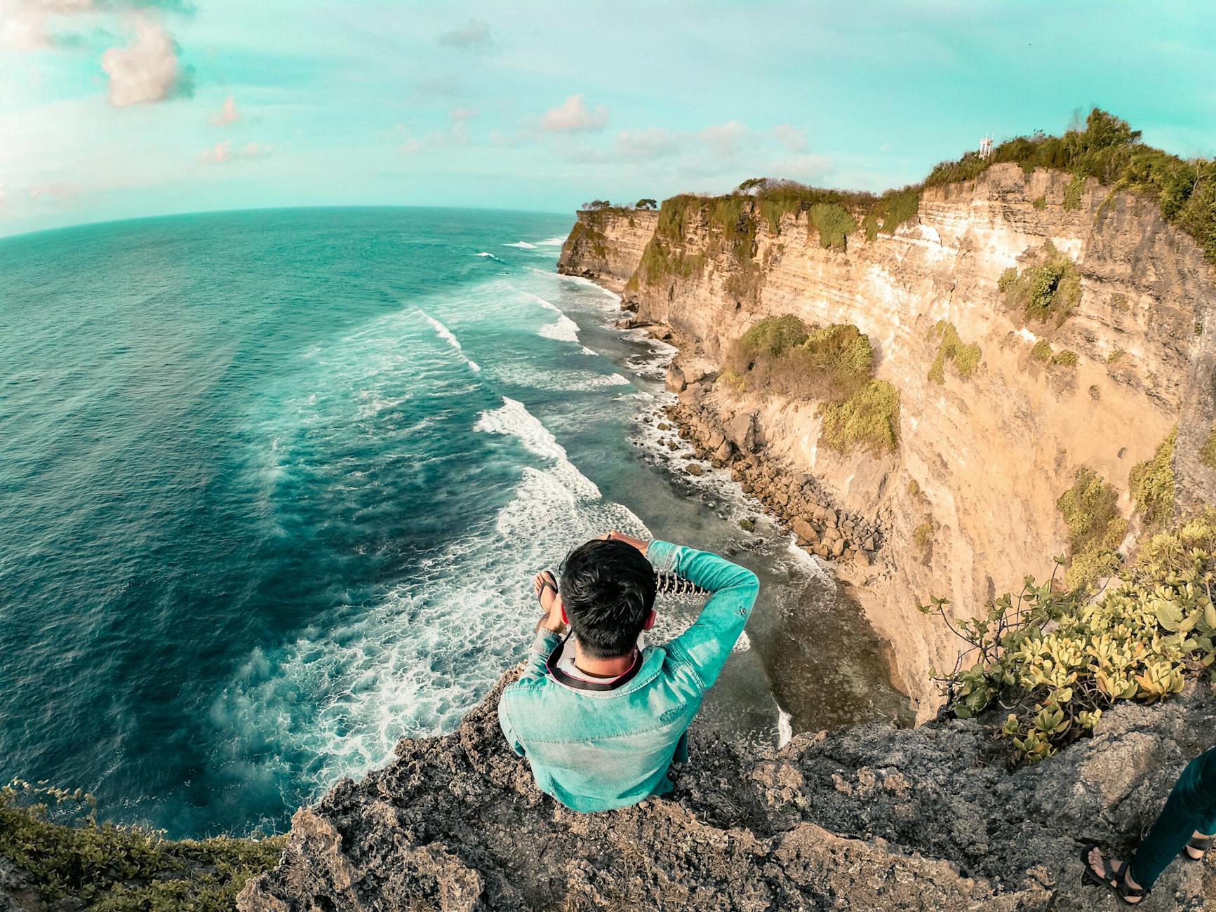 man wearing blue long sleeve top on top of mountain Visa on Arrival in Indonesia